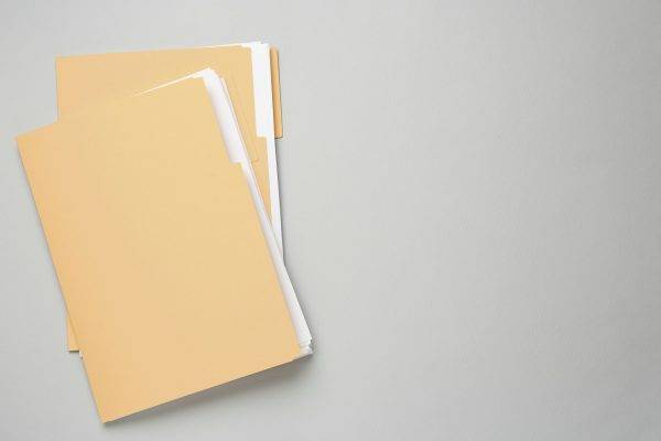 Yellow,Files,With,Documents,On,Light,Grey,Background,,Top,View.